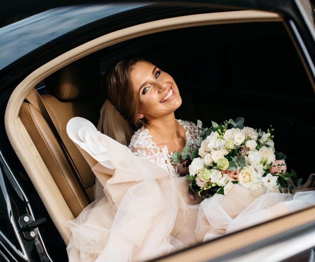 Bride holding a bouquet inside a Boston wedding limo