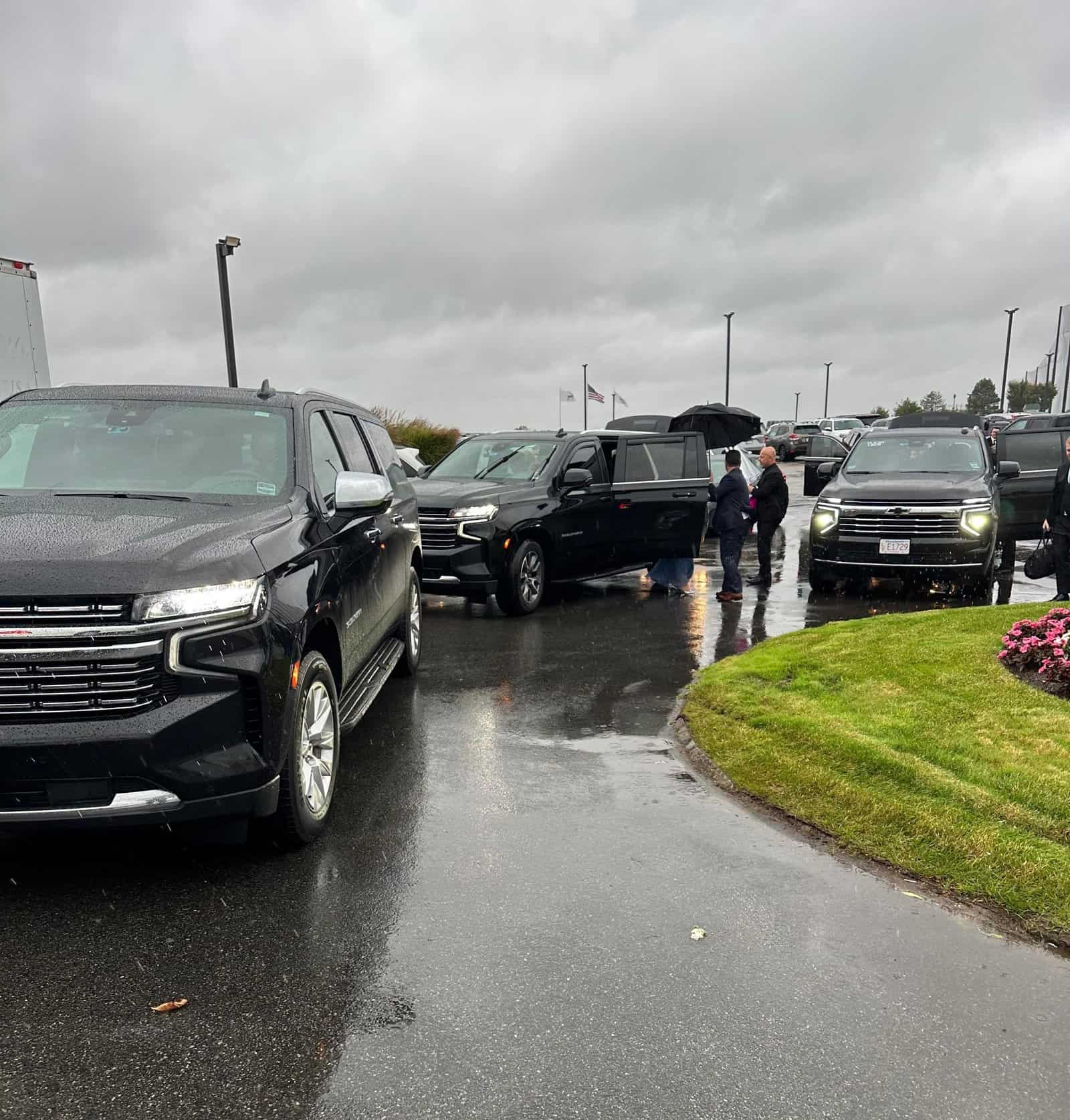 Fleet of black luxury SUVs lined up for corporate event transportation Boston