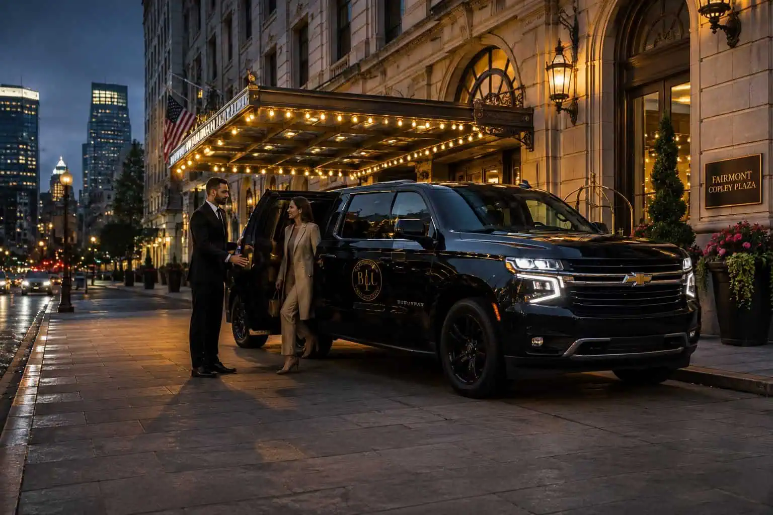 Black SUV at a Boston hotel entrance with a chauffeur assisting a passenger