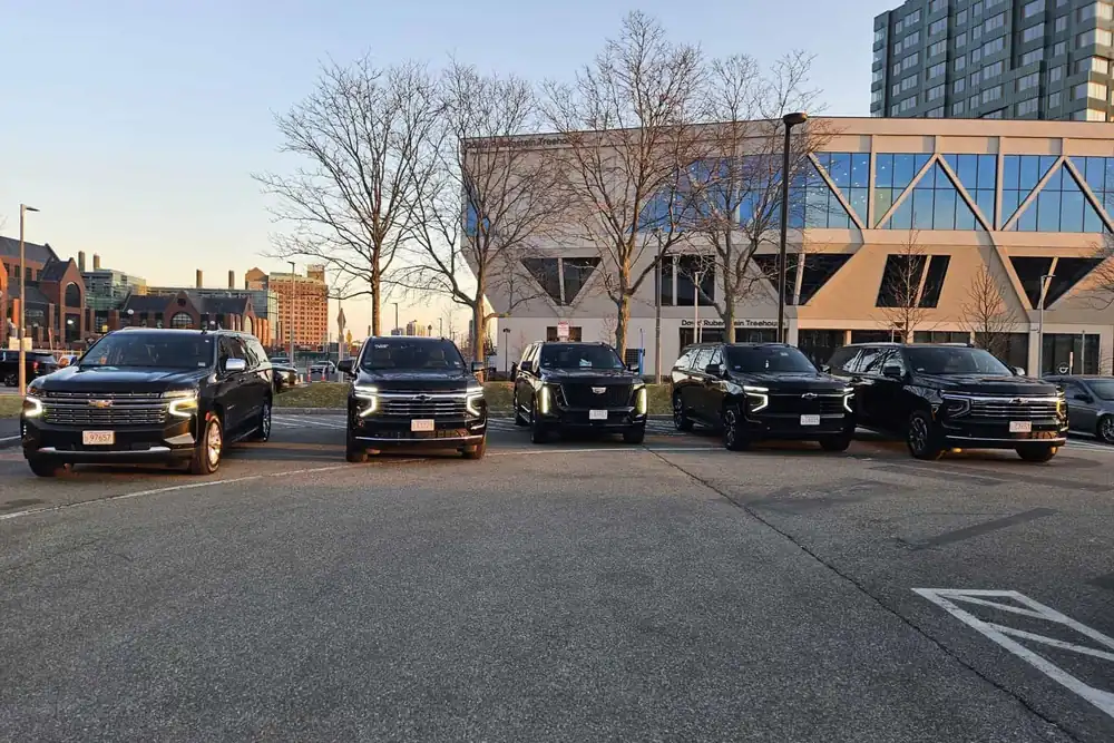 Black luxury SUVs lined up for chauffeur service in Boston